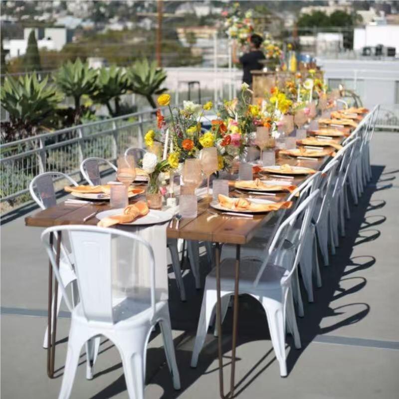 White Tolix Chairs Arranged For Outdoor Rooftop Event