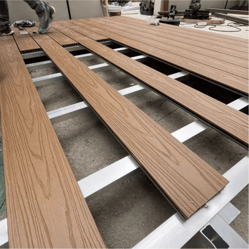 Laying Wood Plastic Composite Decking Boards Outdoors