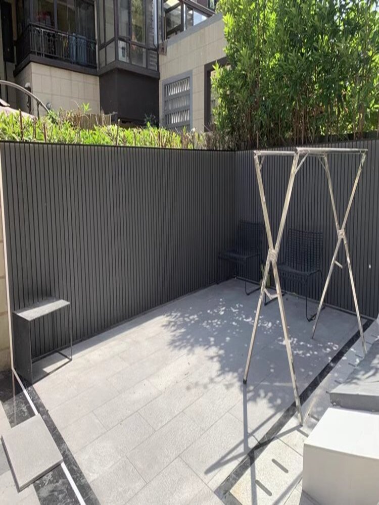 Full View of Dark Grey Outdoor WPC Vertical Slat Boundary Wall in Private Courtyard1